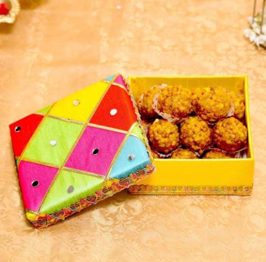 A vibrant multi-colored box designed for Holi hampers, measuring 6x6x3 inches.