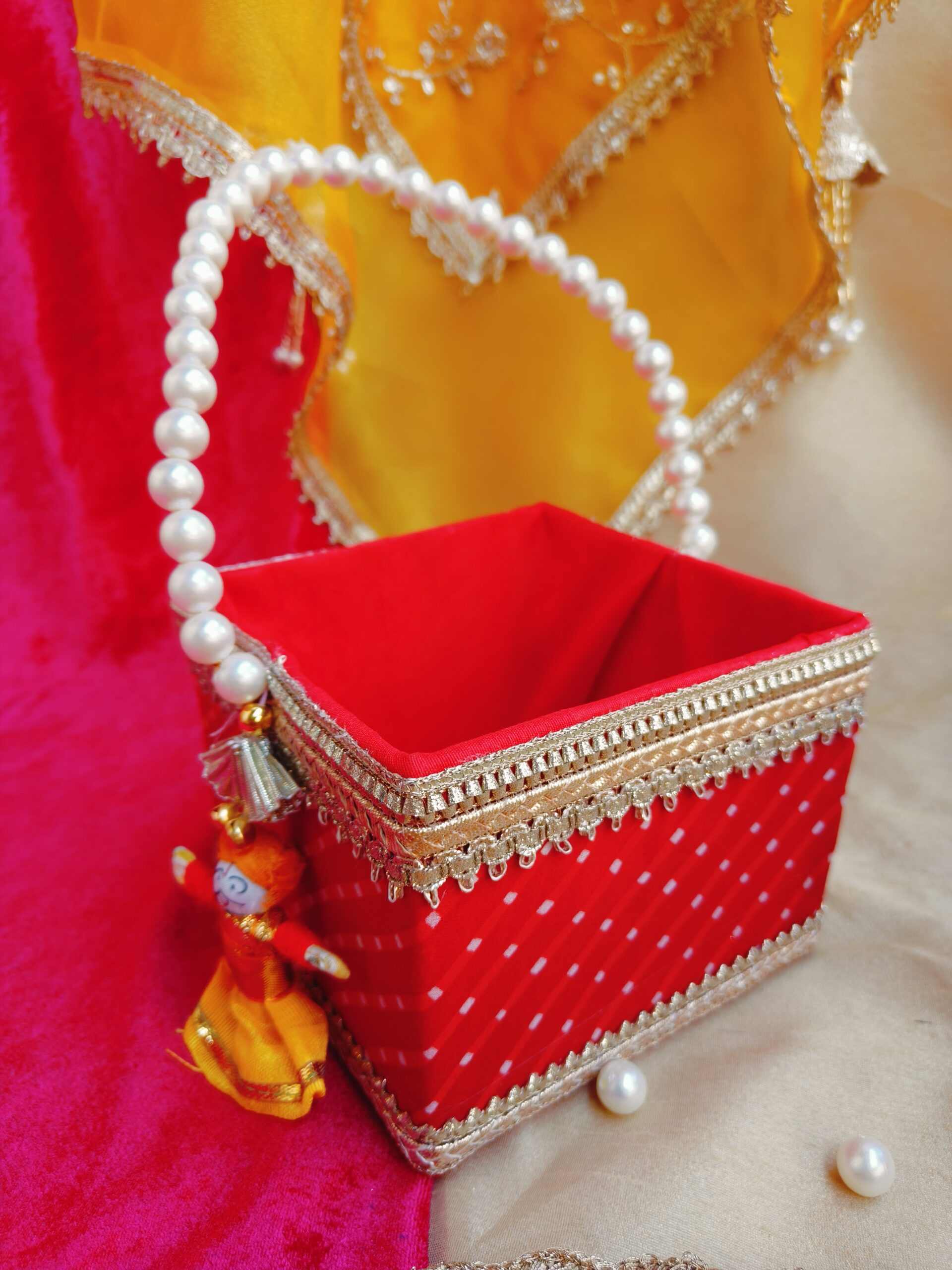 Rajasthani traditional Mothra design Basket with pearl handle, measuring 5 by 5 by 4 inches, ideal for Holi, Gangaur, and Teej festivals as gifting or hamper. Richly adorned with intricate motifs, perfect for adding cultural charm to celebrations