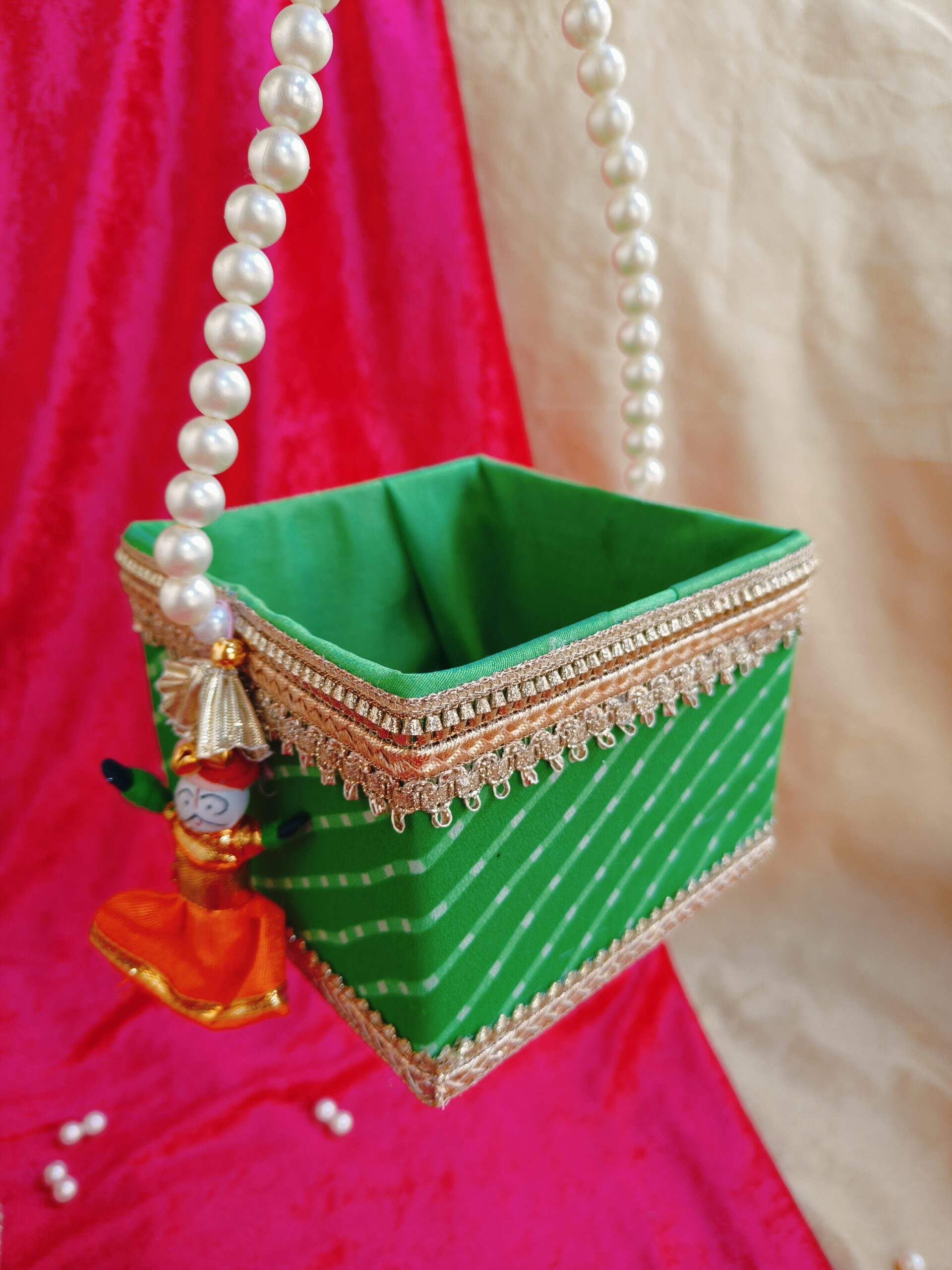 Rajasthani traditional Mothra design Basket with pearl handle, measuring 5 by 5 by 4 inches, ideal for Holi, Gangaur, and Teej festivals as gifting or hamper. Richly adorned with intricate motifs, perfect for adding cultural charm to celebrations.