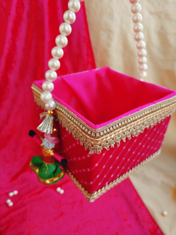 Rajasthani traditional Mothra design Basket with pearl handle, measuring 5 by 5 by 4 inches, ideal for Holi, Gangaur, and Teej festivals as gifting or hamper. Richly adorned with intricate motifs, perfect for adding cultural charm to celebrations.