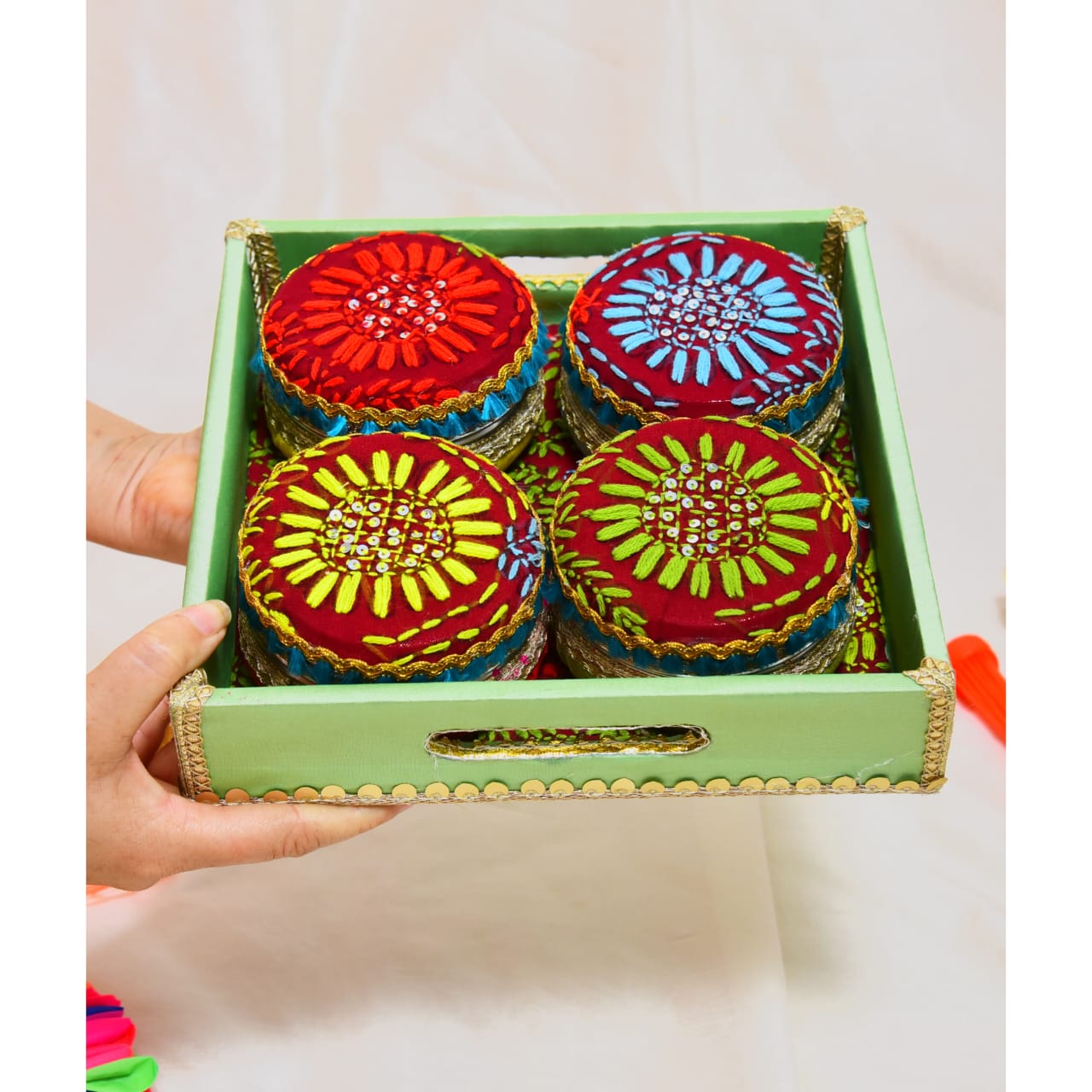 Holi special Fulkari handcrafted hamper set with four steel sweet boxes adorned with traditional embroidery.